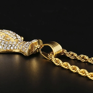 Close-up of hip-hop gold money bag pendant with shimmering rhinestones and shiny chain