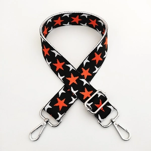 Adjustable wide fabric strap with orange and white star pattern and silver metal clasps