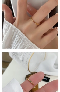 Detailed macro view of 18k gold-plated ring set with a row of rainbow cubic zirconia