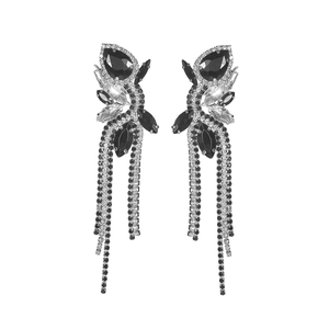 Detailed view of long tassel earrings with black and silver rhinestones in bow shape