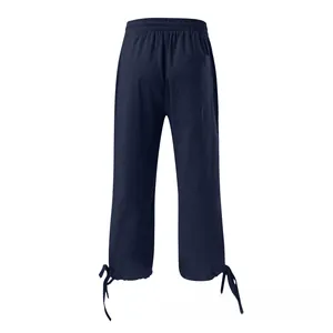 Detail view of dark blue linen pants featuring elastic waist and drawstring hem cuff