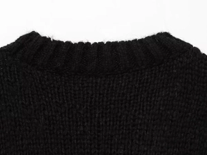 Close-up of black ribbed knit collar on the thick argyle pattern sweater