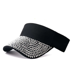 Detail of black sun visor hat with sparkling silver rhinestones on the brim for women