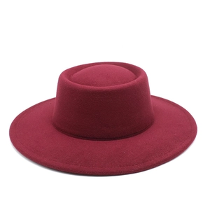 Macro detail of wine red wool fedora hat featuring wide brim and premium felt texture