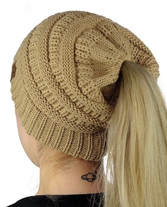 Detail of khaki cable knit ponytail beanie showing the top opening and C.C leather tag