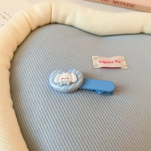 Détail de la pince à cheveux nuage bleu clair avec cœur en résine sur tissu tricoté