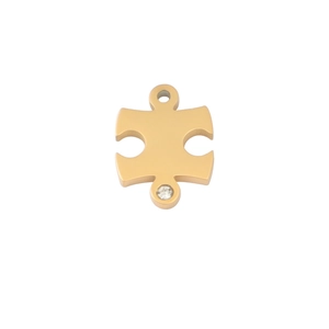 Macro detail of a gold puzzle charm with a small rhinestone and dual connecting rings