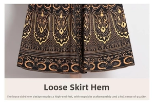 Close-up of loose hem with vintage black and gold paisley patterns on long dress