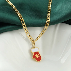 Christmas necklace with red glove pendant and gold snowflake on green silk background