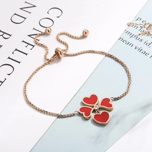 Dettaglio del bracciale quadrifoglio in oro rosa con quattro cuori rossi e cristallo