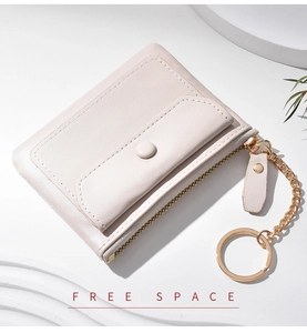 Detail of pink PU leather coin purse with golden zipper, key chain, and snap button pocket