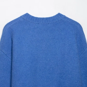 Minimalist royal blue knit cardigan featuring a ribbed round neck and soft long sleeves
