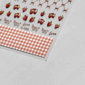 Close-up of 5D embossed strawberry nail stickers with 3D texture and pink bows