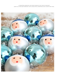 Détail de boules de Noël bleues et ornements Père Noël sur une surface en bois enneigée