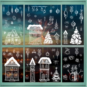 Festive Christmas window stickers with white snowman, cabin and snowflakes on glass