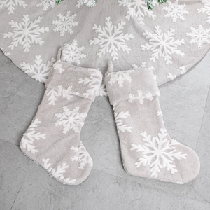 Grey plush Christmas stockings and tree skirt set featuring large white snowflake patterns