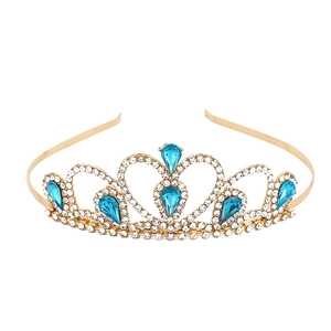 Detail of gold princess crown featuring blue teardrop stones and sparkling rhinestones