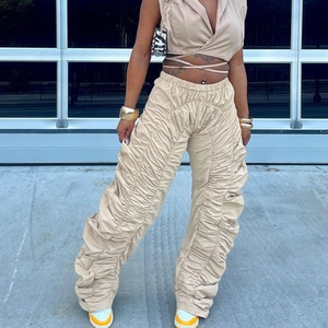 Close-up of khaki halter top and ruched drawstring wide-leg trousers detail