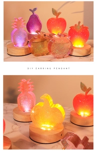 Luminous LED wood base displaying resin DIY fruit pendants with sparkling glitter flakes