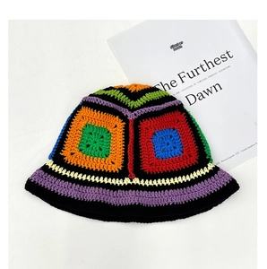 Detailed view of the colorful crochet flower pattern on a handmade knit bucket hat