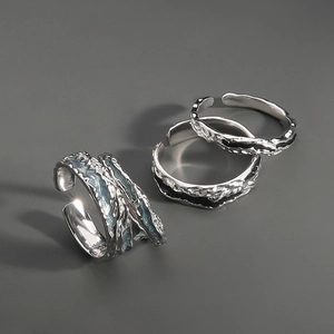 Macro detail of silver S925 adjustable rings with lava texture and colorful epoxy accents