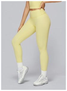 Detail of high-waist yellow yoga set with seamless stitching and body-shaping contours