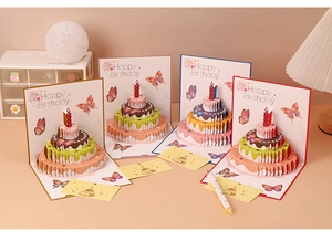 Detailed view of 3D pop-up birthday cards with butterfly cake designs in four colors