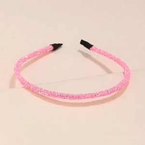 Detail of pink sequin headband with glitter finish and black protective ends