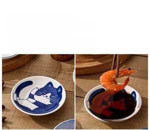 Detailed view of Japanese cartoon cat ceramic sauce dish with blue hand-painted glaze