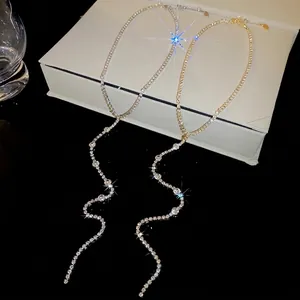 Elegant rhinestone tassel Y-necklace in gold and silver finish shown on jewelry box