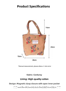 Detail view of yellow corduroy tote bag featuring Keep Smiling print and magnetic buckle