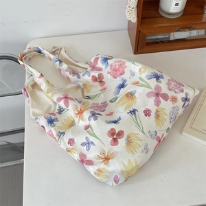 Detail of floral mesh tote bag with colorful embroidery and a rustic aesthetic look