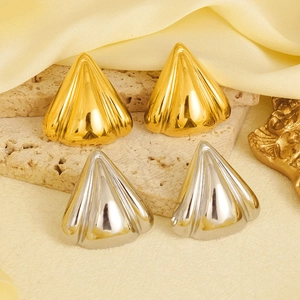 Macro detail of geometric 304 stainless steel earrings with petal fold texture in gold and silver