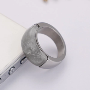 Detail view of a polished titanium steel ring with a large grey translucent gemstone