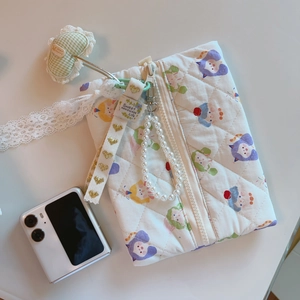 Detailed quilted storage bag with cartoon cat print, lace ribbons, and pearl handle charm