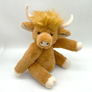 Detailed view of the soft brown long fur and horns on the highland cow plush toy