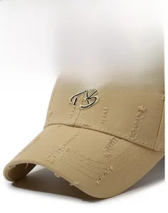 Close-up of distressed cotton baseball cap with embroidered B letter and ripped brim detail