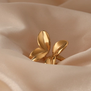 Creative 316L stainless steel gold flower petal open ring on champagne silk fabric
