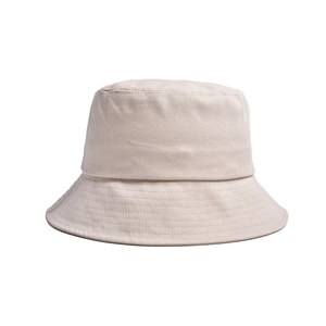 Close-up of the beige cotton canvas fabric texture and fine stitching on the bucket hat