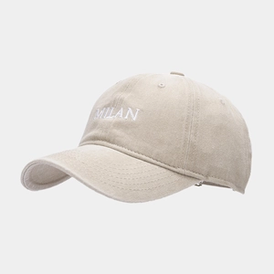 Close-up of MILAN letter embroidery on beige washed canvas baseball cap