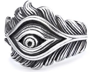 Macro detail of gothic stainless steel ring with eagle eye and engraved feather patterns