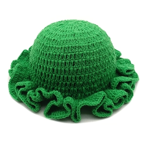 Green crochet knitted winter hat with wavy ruffle brim and round crown for stylish warmth