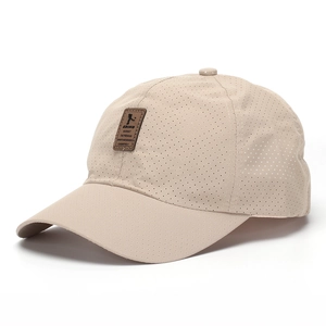 Detail of breathable khaki mesh baseball cap with premium leather sports logo patch