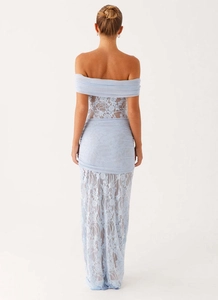 Detail of light blue lace bodycon dress showing sheer panels and tiered hem from the back