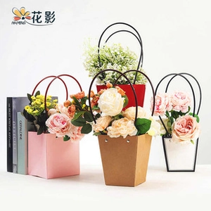Detail of portable trapezoid paper flower boxes with round black handles and rivet decor