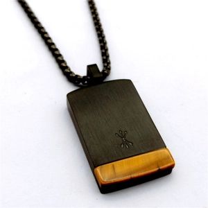 Detail of square natural tiger eye stone pendant with engraved arrows on black metal