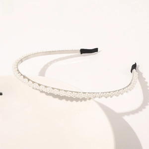 Detail of three-row pearl headband with elegant silver metal frame and black tips