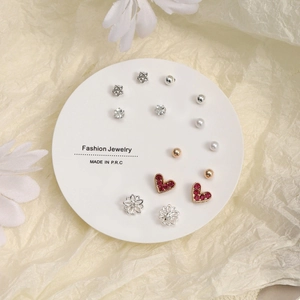 Nine-pair set of minimalist gold and silver earrings with heart and star charms