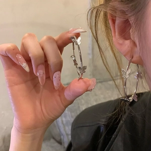 Elegant silver bow hoop earrings for women featuring textured butterfly charms for a chic look