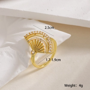 Macro detail of gold fan-shaped ring showing white zircon inlay and 2.5cm width measurement